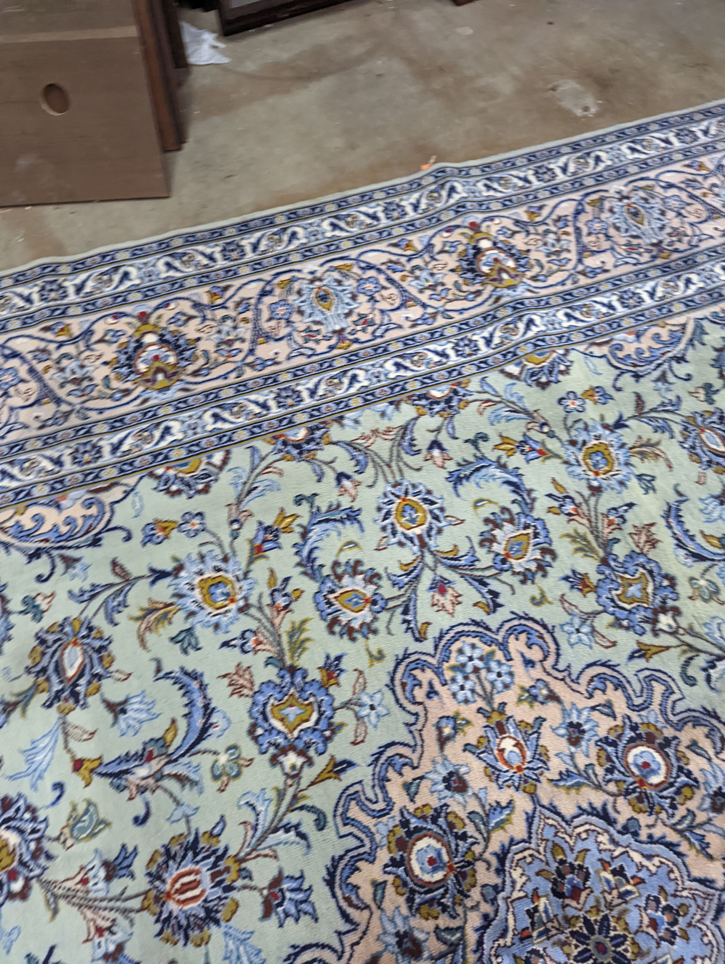 A Kashan pale green ground carpet, 410 x 296cm